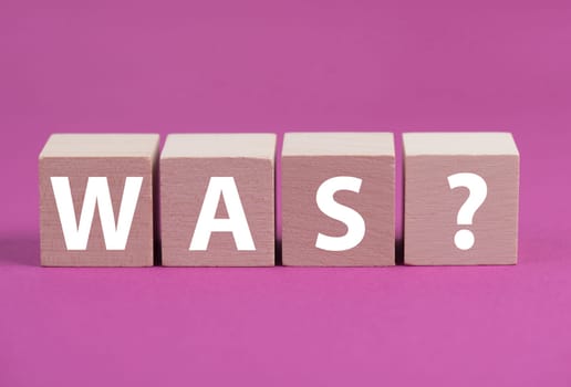 The german word for what is standing on wooden cubes, pink colored background