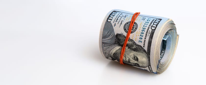 A roll of dollars on a white background. One hundred American dollar bills. Place for logo, lettering, layout.