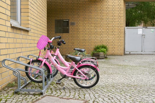 parked children bicycles waiting in front of a kindergarten in Berlin