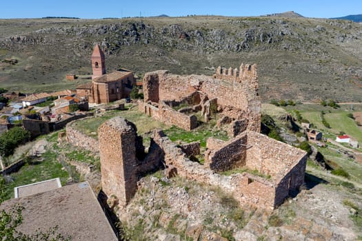 Castle ofAranda de Moncayo, is a 12th century fortress, Zaragoza Spain. In the background the church
