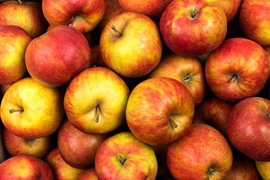 red fresh and tasted apples as a background