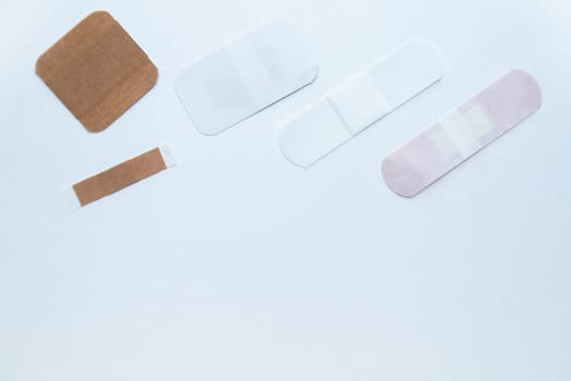 Bactericidal patches of various shapes and sizes lie on a white background with a place for text. High quality photo