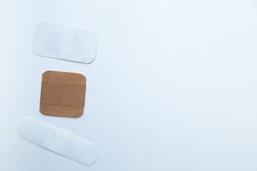 Bactericidal patches of various shapes and sizes lie on a white background with a place for text. High quality photo