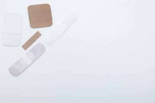 Bactericidal patches of various shapes and sizes lie on a white background with a place for text. High quality photo