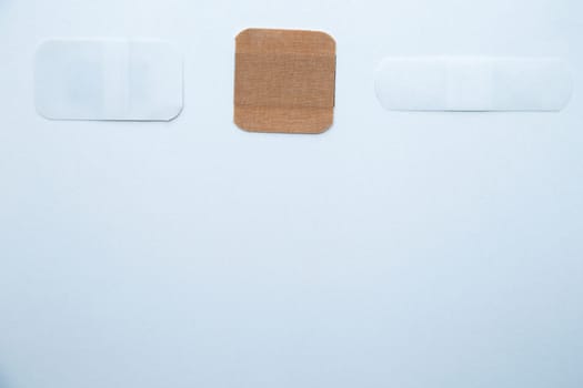 Bactericidal patches of various shapes and sizes lie on a white background with a place for text. High quality photo