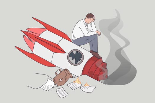 Failed and crashed business rocket startup. Vector concept illustration of sad business manager standing on broken launching missile.