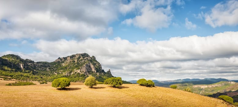 Beautiful blue sky with clouds over the limestone formations of Ogliastra, Sardinian dolomite formations. Nature of an unspoiled landscape.