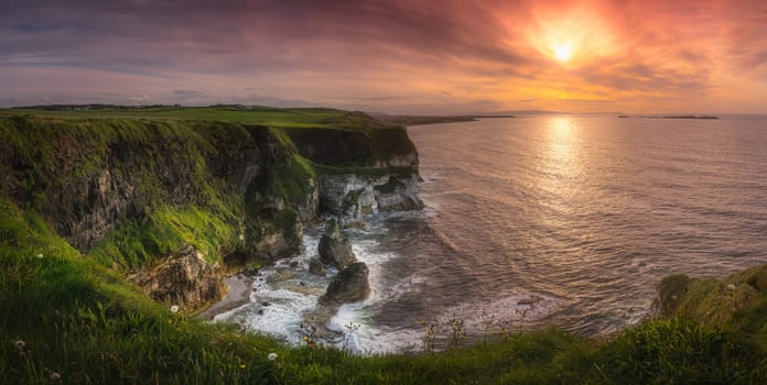 Wide panorama with beautiful white, limestone cliffs at dramatic sunset, seen from Magheracross viewpoint, Bushmills, Northern Ireland