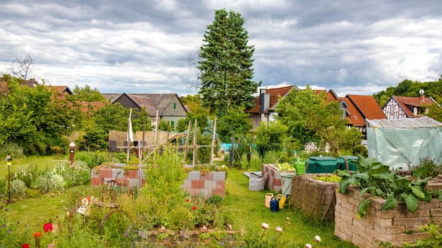 Beautiful garden with high garden beds and lush greenery in summer.