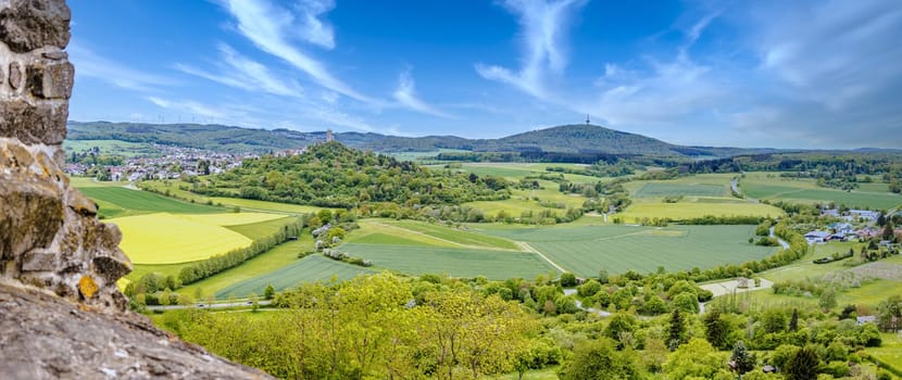 Panorama View on castle ruin vetzberg from the medieval castle ruin gleiberg in summertime with beautiful poppy meadows