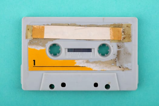 Old used audio tape isolated over green Background