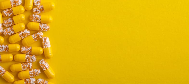 Top View from yellow pills over yellow background