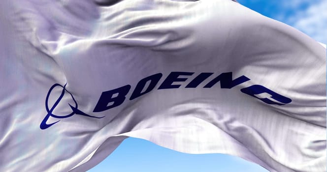Chicago, IL, USA, july 2021: White flag with the Boeing logo waving in the wind. The Boeing Company is a US aviation industry producing aircraft for both civil and military use