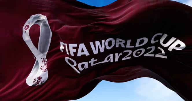 Doha, Qatar, October 2021: A flag with the 2022 Fifa World Cup logo flapping in the wind. The event is scheduled in Qatar from 21 November to 18 December 2022