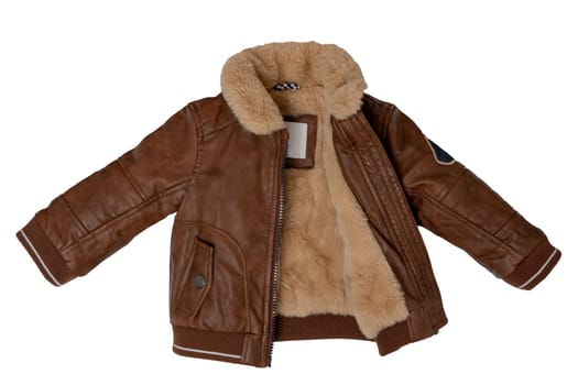 Top view of clothes for child boy isolated on a white background. Trendy stylish brown leather jacket with beige fur. Autumn and winter fashion for kids.