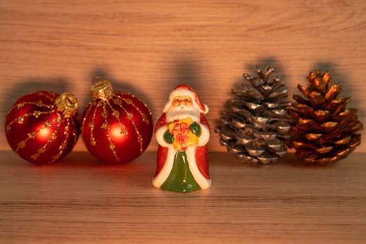 Christmas concept with Santa Claus porcelain figurine holding a gift box