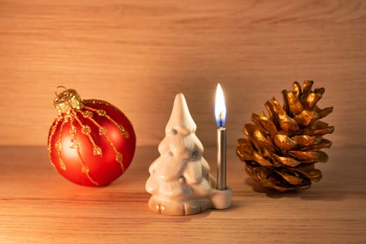 Christmas tree candle holder with a burning silver candle