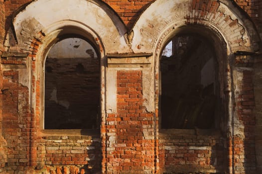 Destroyed wall. windows in brick wall of old ruined building