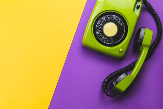 Classic phone with handset. vintage green telephone with phone receiver on color background. old communication technology. copy space