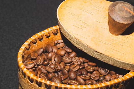 Coffee beans in a bark container. roasted coffee beans in a wooden jar