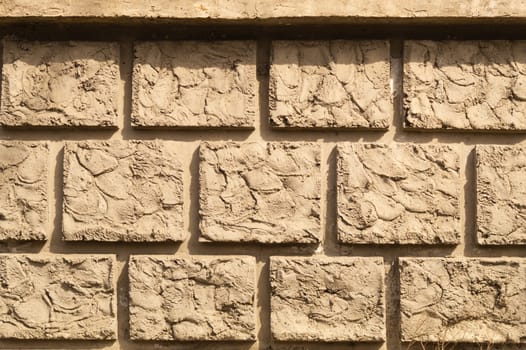 Old brick wall background. wall from squared bricks. cracked stone wall texture