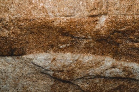 Stone texture background close up. brown stone with cracks on the surface
