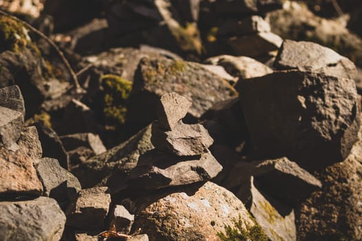small stone turrets in the forest. stone sculptures background