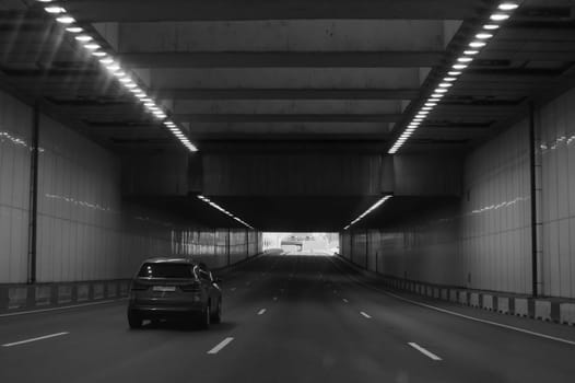 Car moving in the tunnel. car drives through the tunnel black and white