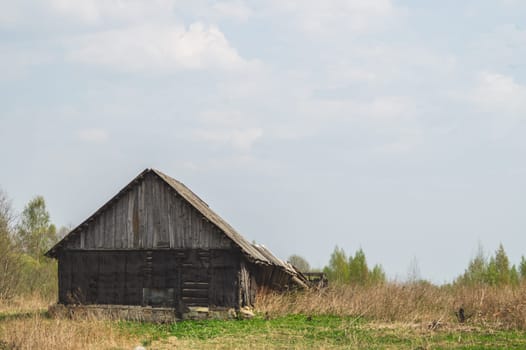 Old wooden house on the countryside. house standing alone among the field