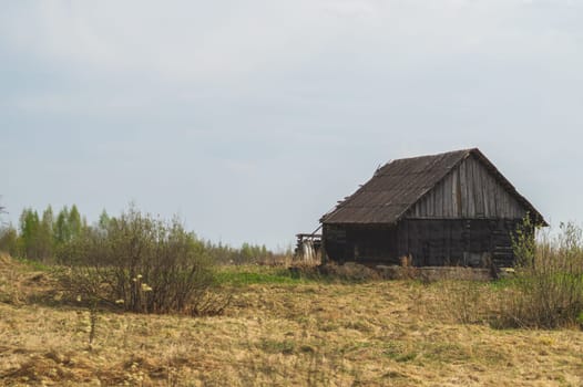 Old wooden house on the countryside. house standing alone among the field