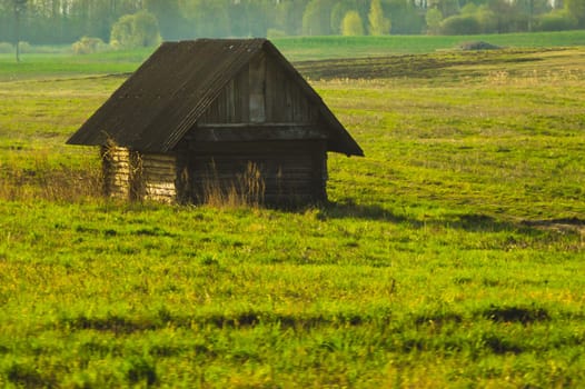Old wooden house on the countryside. house standing alone among the field