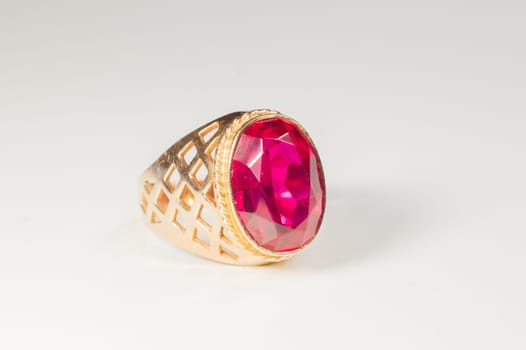 Golden ring with ruby isolated on white background