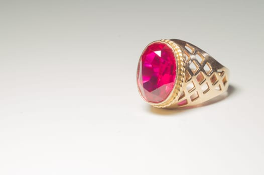 Golden ring with ruby isolated on white background