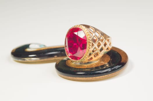Golden ring with the ruby isolated on white. jewelry background