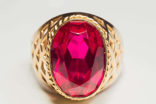 Golden ring with ruby isolated on white background