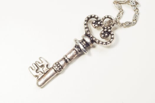 Vintage key with the chain isolated on white background. safety and security concept
