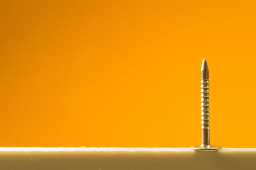 Metal nails isolated on yellow background