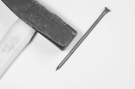 Hammer with a metal nail isolated on white background