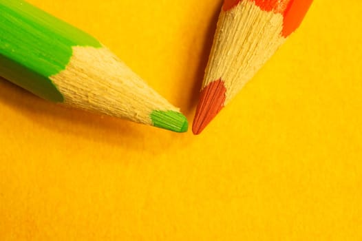 Colorful pencils isolated on yellow background. drawing supplies