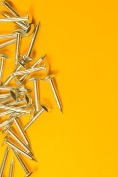 Metal nails isolated on yellow background