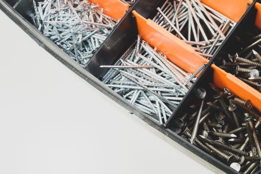 Various metal nails in toolbox background. nails in the cells of the box. copy space