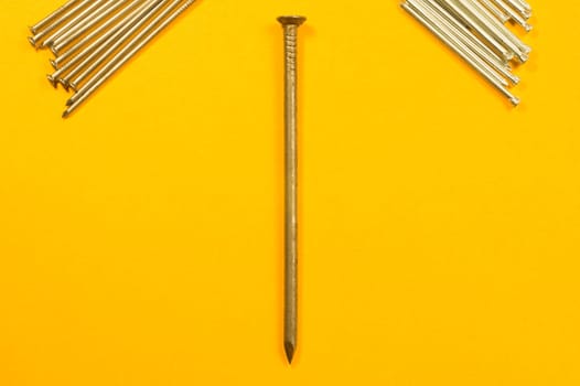 Metal nails isolated on yellow background