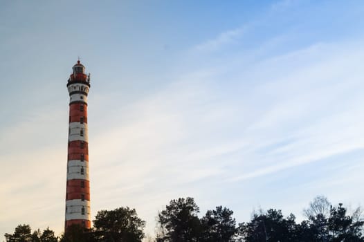 Lighthouse in the forest. red and white lighthouse background