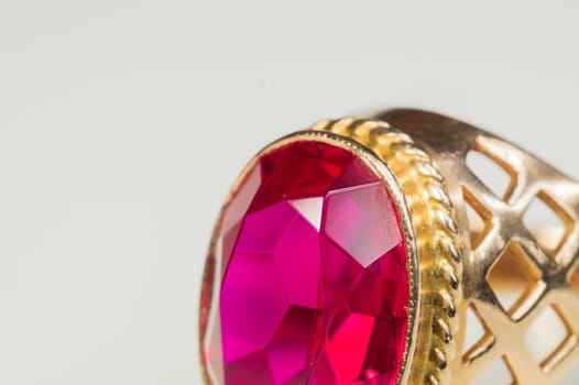 Golden ring with ruby isolated on white background