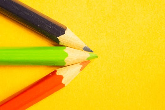 Colorful pencils isolated on yellow background. drawing supplies