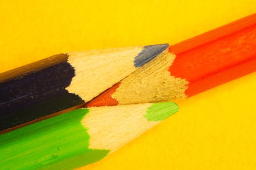 Colorful pencils isolated on yellow background. drawing supplies