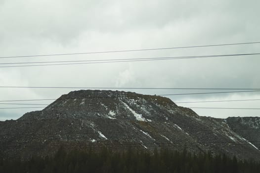Mountain landscape background. snowy hills and forest. power lines in mountains