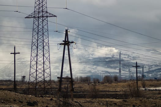 Mountain landscape background. snowy hills and forest. power lines in mountains