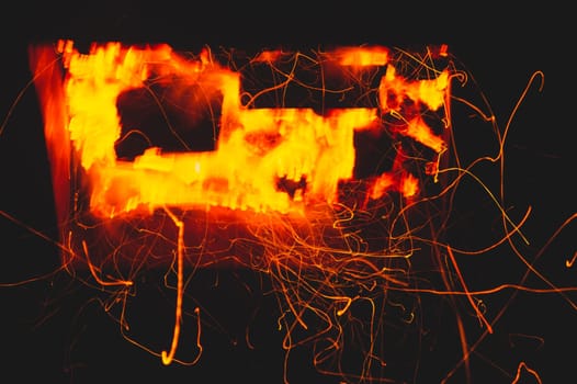 Fire flames with sparks in the dark background. bonfire at night