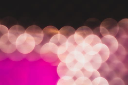 Abstract colorful bokeh defocused lights in pattern of straight rows. holiday background